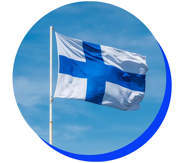 Finnish flag flying against a blue sky with wispy clouds. The flag has a blue cross on a white background.