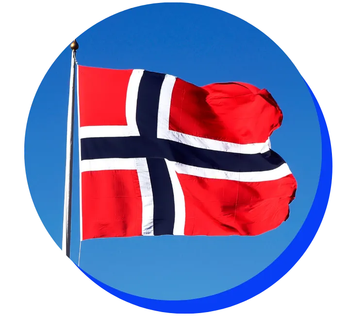 Norwegian flag flying on a flagpole against a bright blue sky. The flag is red with a blue and white Nordic cross.